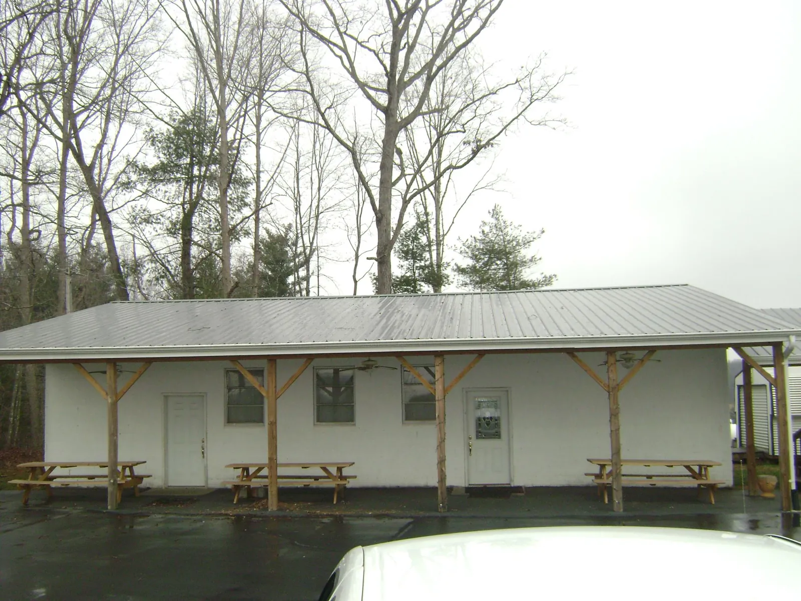 Gray metal roof over a block building with a timber post porch in Mcleod