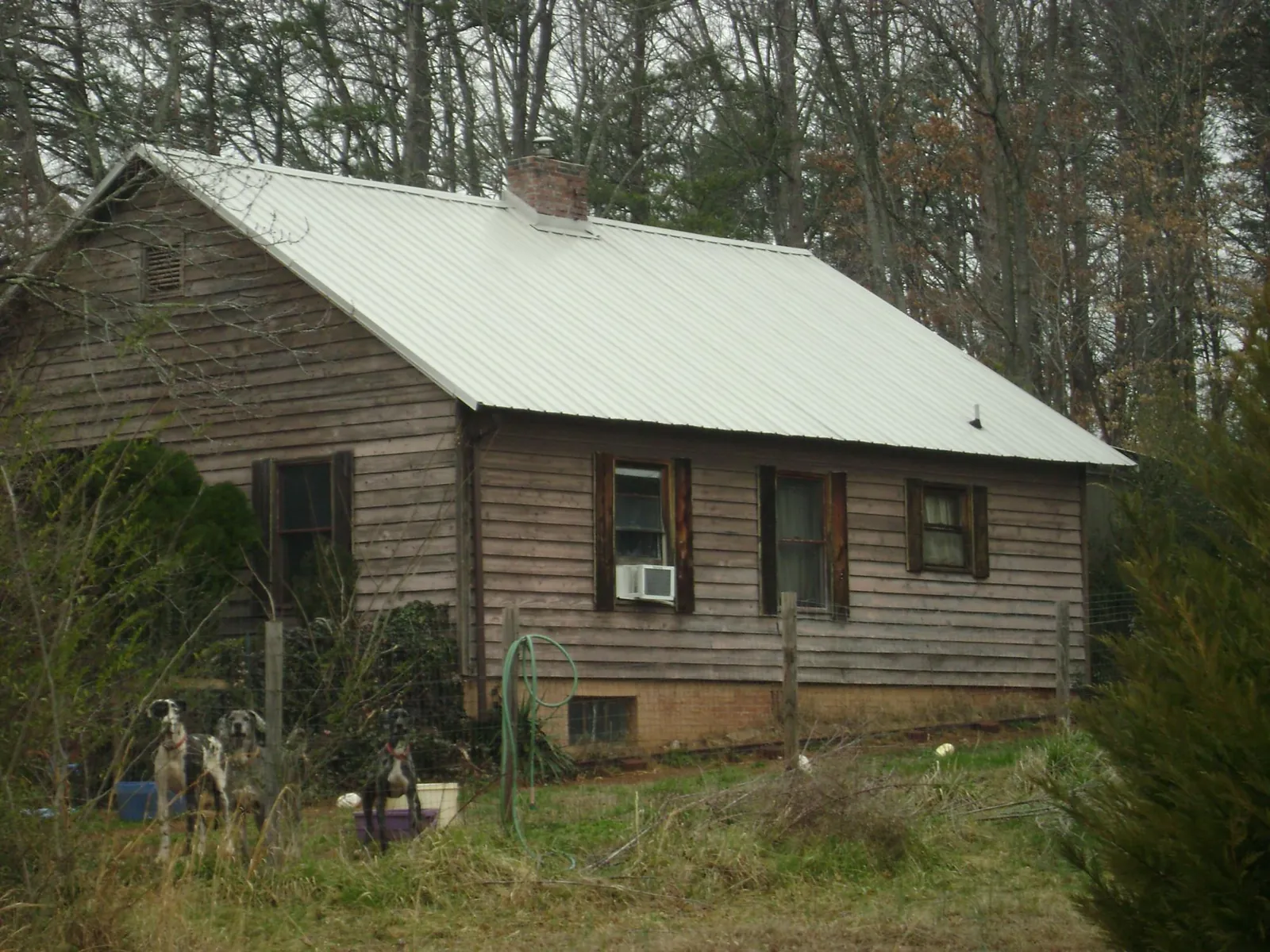 White metal roof on an old wood sided farmhouse, from a Metal Roof Installation job in Mcleod